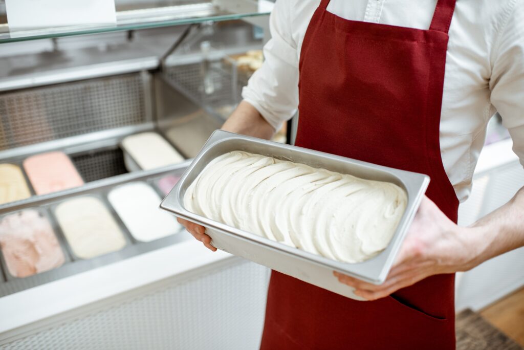 Holding tray with ice cream in the shop